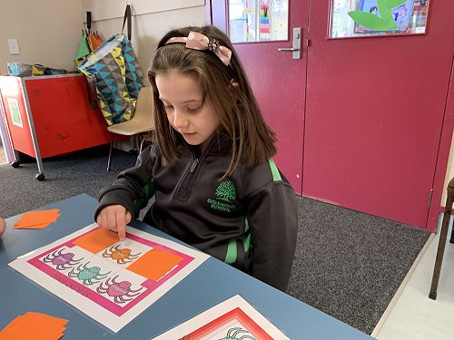 Brielle working with a buddy to learn new words and sounds.
