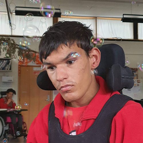 Salih enjoys the sensory component of our JOLT class. We often finish up with bubbles. Salih loves them.