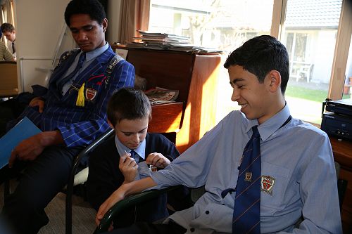 Alexander sewing on buttons.