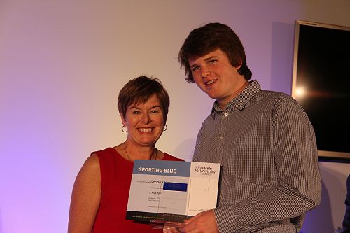 Chief Operating Officer Philippa Jones presents Declan Keaney with his Lincoln University Blue for Hockey