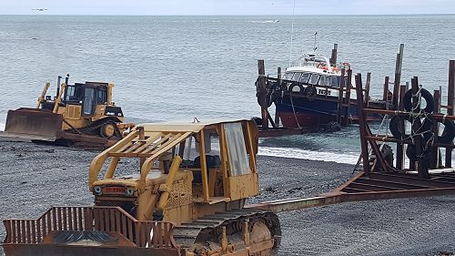 Launching at Ngawi Beach on a rare calm day.
