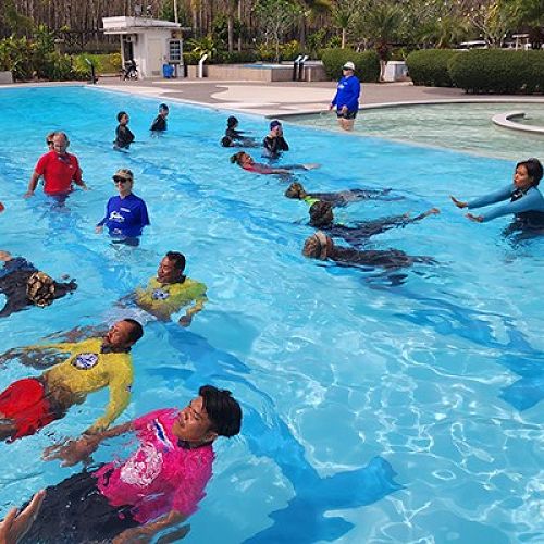 Instructors teach a swimming class funded through contributions from Rotary members