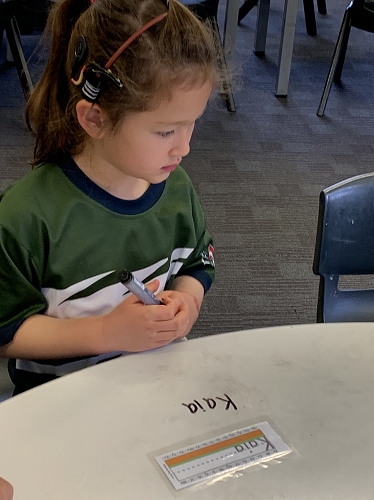 Kaia practising writing her name.