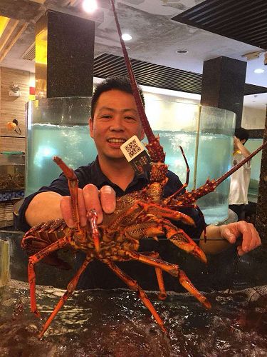 Shanghai restaurateur receiving his weekly delivery of Wild Legend tagged lobsters.