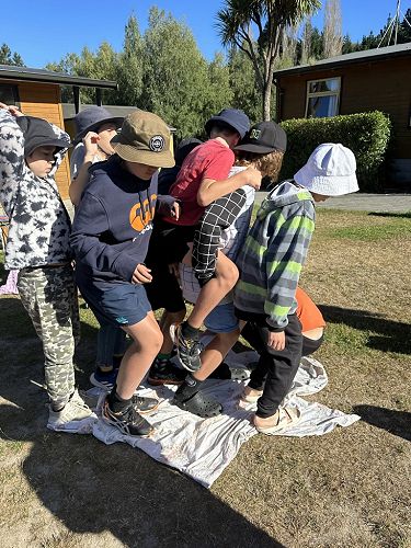 This team trying to turn the sheet over while all standing on it.