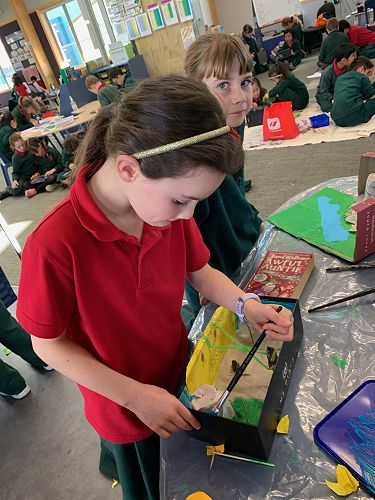 Lillie painting her diorama.
