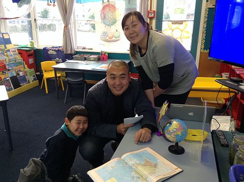 Zachary shared Action Stations with his Mum and Dad. Here they are at the 'Inquiry Table' finding their special places in China.