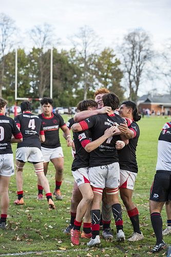 Try time: The boys celebrate after a well-fought try.