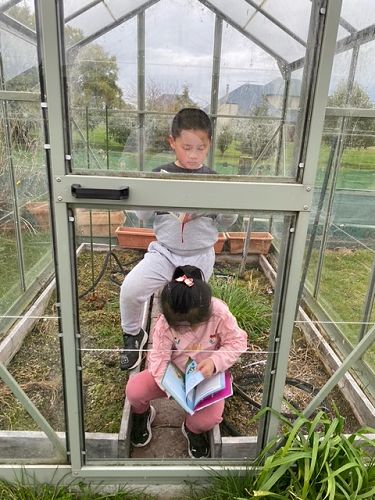 Dylan and Chelsea Wang reading in an unusual place