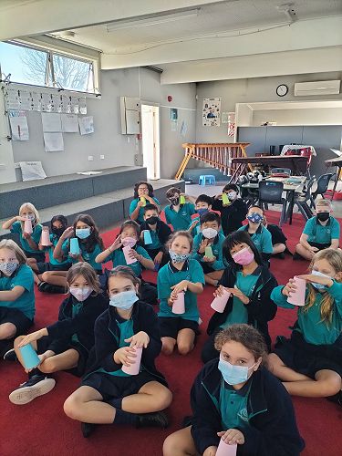 Students do a cup game during their CRT music lessons to learn to read music rhythms.