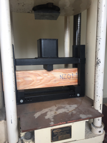 The Dennison universal machine pressing a timber sample