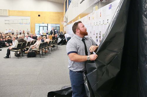 Former student and current staff member, Mr Daniel Teka, unveils part of the timeline