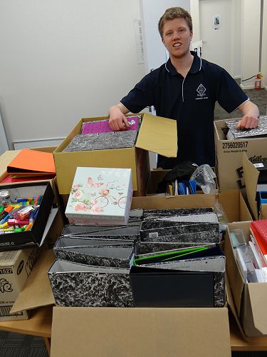 Sam with Choose Kids makes a delivery of stationar