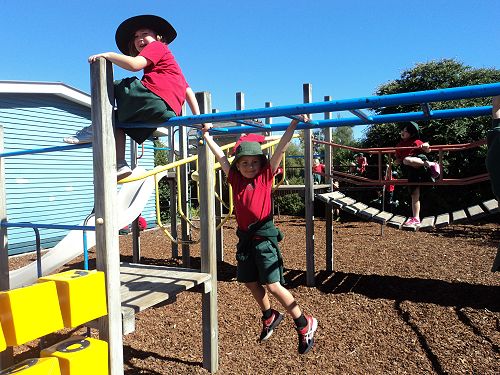 CJ and Emily on the monkey bars.