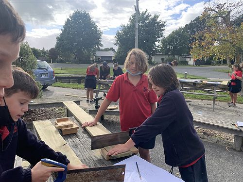 Tom and Riwai hard at work under the supervision of their teams