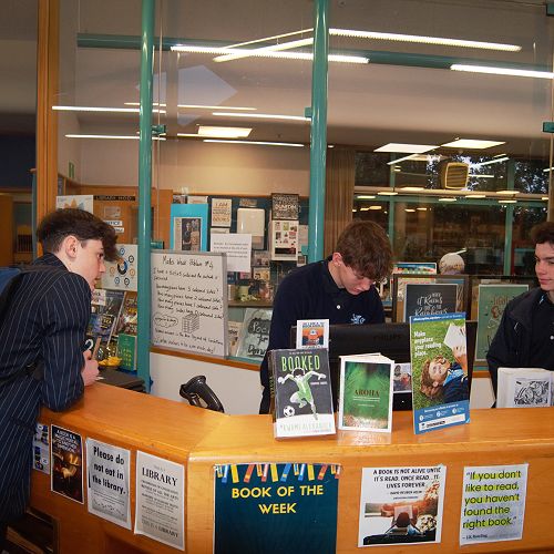 Bailey Gray and Joshua Evangelou (10)  issuing a chromebook to Carson Wills (10)