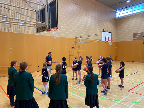 Intermediate Basketball members listening to Brents explanation of the drills they are about to attempt 