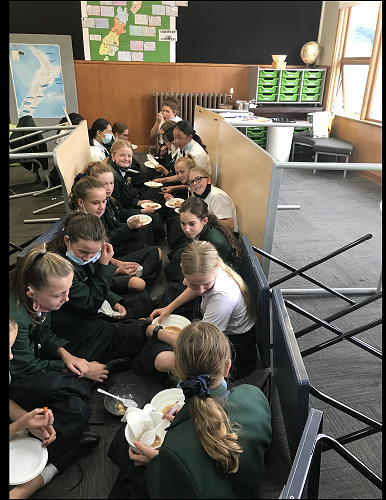 Mrs Cheyne's class share stew and bread pudding while sitting in the trenches.