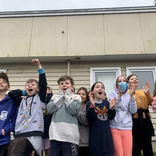 Cheers, gasps, and clapping as some of the seniors watch their old classroom tumble to the ground
