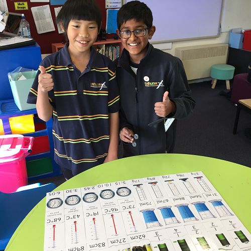 Ashton and Nimesh display the completed puzzles.