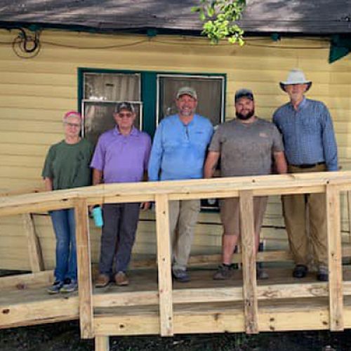 Members of the Rotary Club of Henderson, Texas, spend their Saturday building a wheelchair ramp.