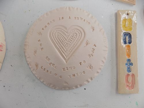 Before glazing, a translation from the Koran - "There is a reward for being kind to every living thing".       A unity hanging message.