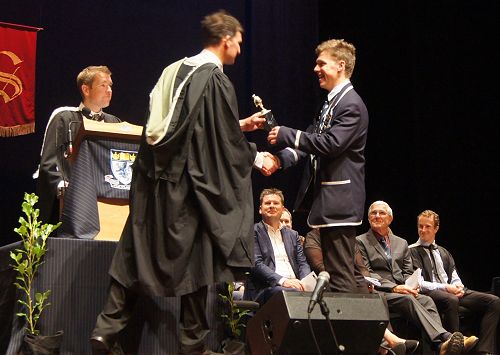 Malachi Buschl presents Mr Scott with number five, of six, trophies