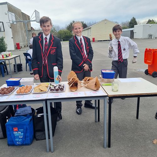 Year 9s man their market stalls on Market Day.