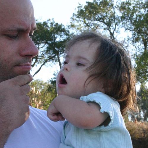 Father and daughter using the Makaton sign for dog