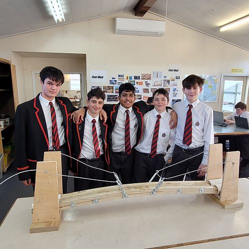 Junior MTC students with the bridge they designed and built.
