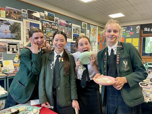 The year 8's posing with the chocolate and meringue filled GIANT cookie
