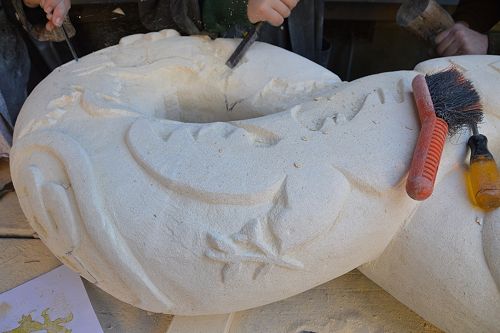 The dove is flying out of the stone.