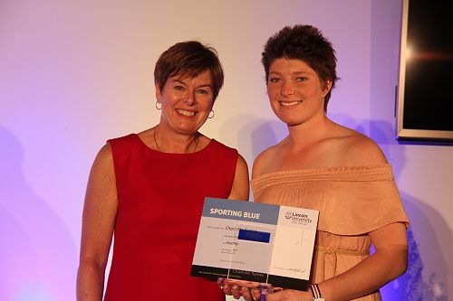 Chief Operating Officer Philippa Jones presents Charlotte Symes with her Lincoln University Blue for Hockey