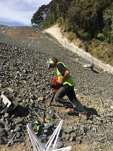 Ross Creek stars - co-creator Ross Sinclair progressing installation on the
dam face. Image 