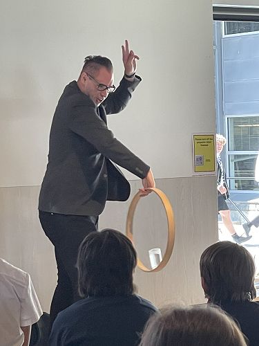 Brendan Dooley, a magician, comedian and motivational speaker demonstrates one of his tricks while sharing his life leadership lessons 