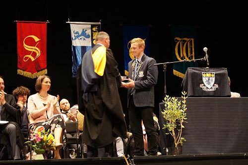 Mr. McIvor presents George with his award for Dux