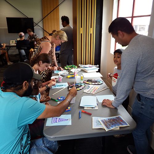 Children and their parents making decorations at a pre-Christmas workshop.
