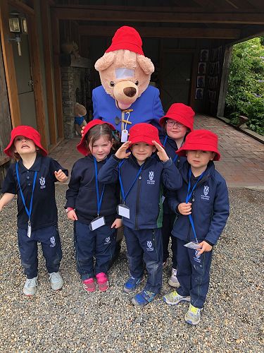 Children posing with Paddington Bear