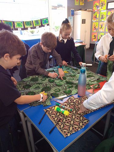 Connor Sinclair, Charlie French and Charlotte Bloxham cutting and measuring their fabric