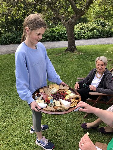 Harriet delivering a platter of delicious goodies