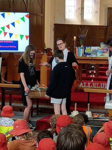 Rev'd Rose Scott blesses pennants, Port Chalmers Primary School Service