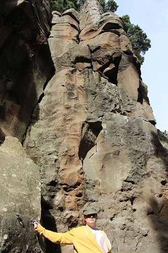 Emily O'Neill standing by the basalt cliffs at Mt Horrible.