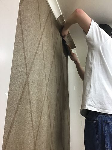 Ryan doing the wall papering for Ara