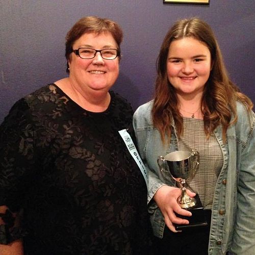 Jill de Joux, past pupil of Mercy College and one of the event organisers, presents Sheridan Ioane with an award from the SCDL Singing Competition 2018