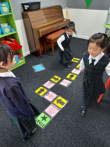 Tarina, Heidi and Daisy creating and following coding action cards.
