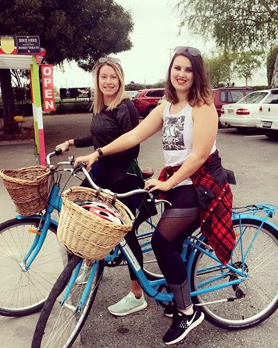 Kelsey (right) enjoys a biking excursion.