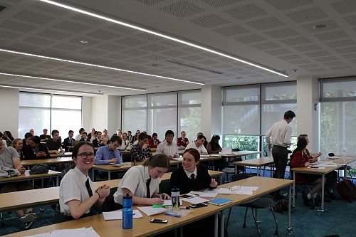 Behind the debating teams sits the panel of adjudicators, including a representative from NZSC 