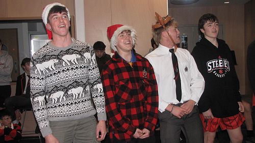 The sound of Christmas carols rang through the boarding house.