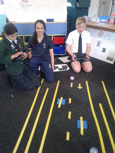 Freya Ferro, Rhianjali Giles and Alban Boaden-Trotter testing their coding on their elaborate road and footpath.