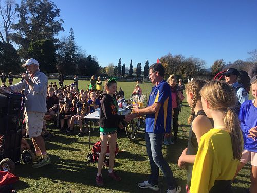 Bella Cain-Townley winner of the Yr8 girls getting presented a chocolate bar from Tasman Mayor Tim King